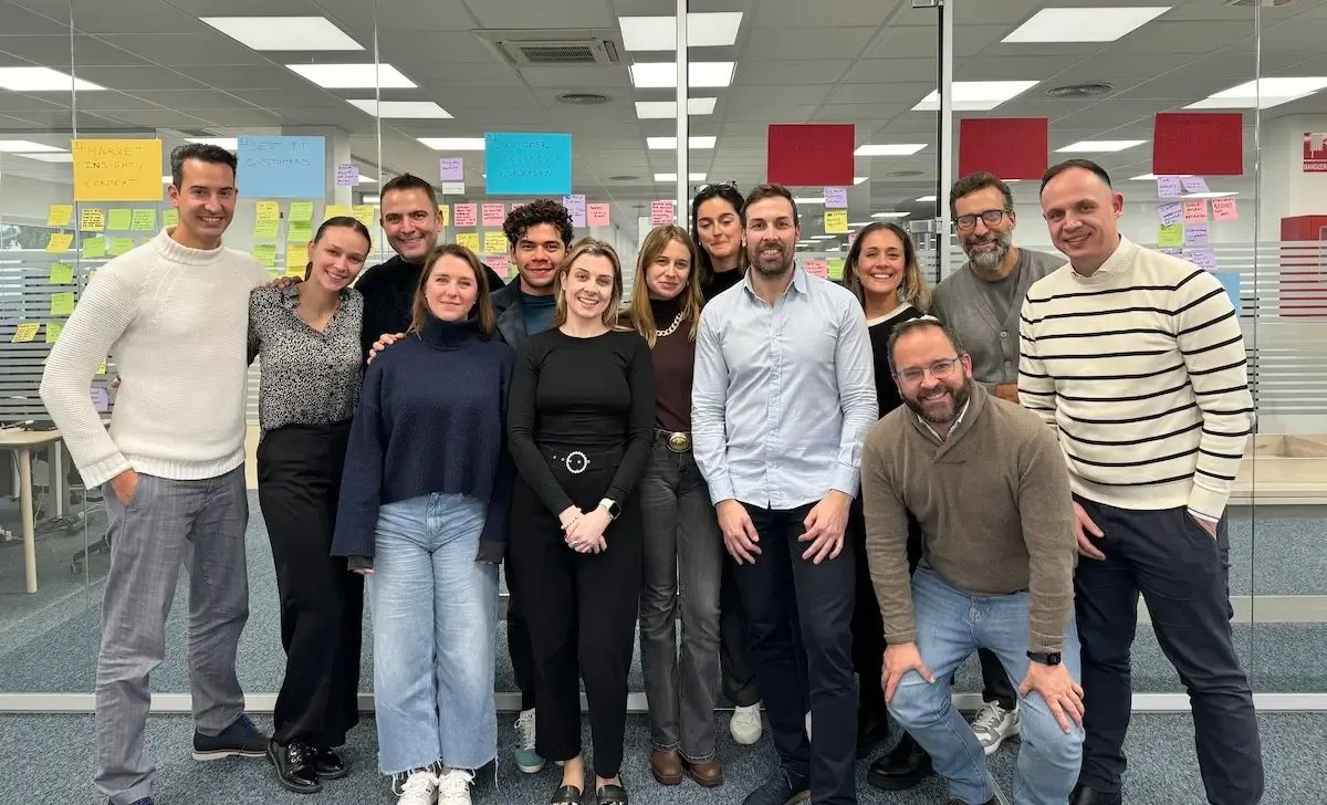 A team smiles together after a workshop.