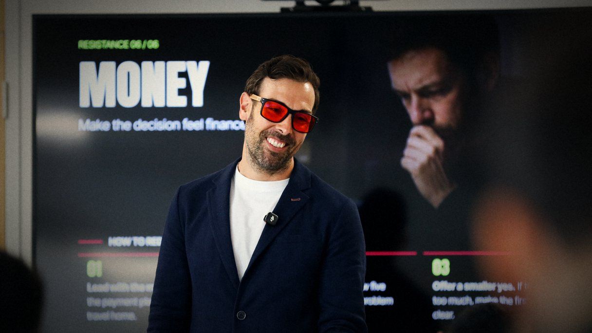 Jose smiling next to a slide about money risk